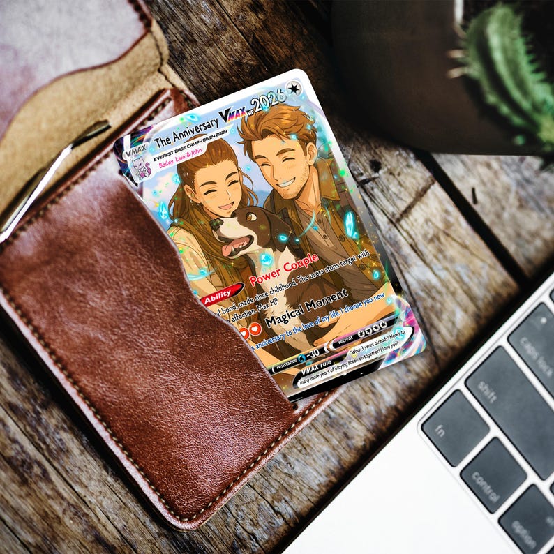 May include: A custom trading card featuring an illustrated couple and a dog, titled The Anniversary VMAX. The card includes text such as Power Couple, Magical Moment, and Everest Base Camp 08.24.2024, with a Mew icon and various game-style statistics.