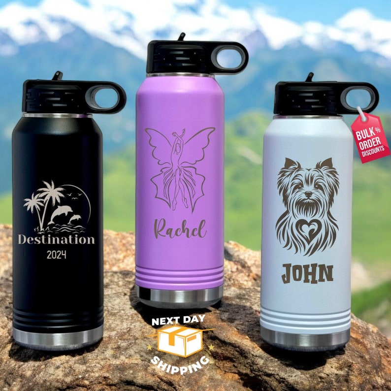 May include: Three stainless steel water bottles with different designs and names. The first bottle is black with a palm tree and dolphin design and the text "Destination 2024". The second bottle is purple with a butterfly design and the name "Rachel". The third bottle is light gray with a Yorkshire Terrier design and the name "John".