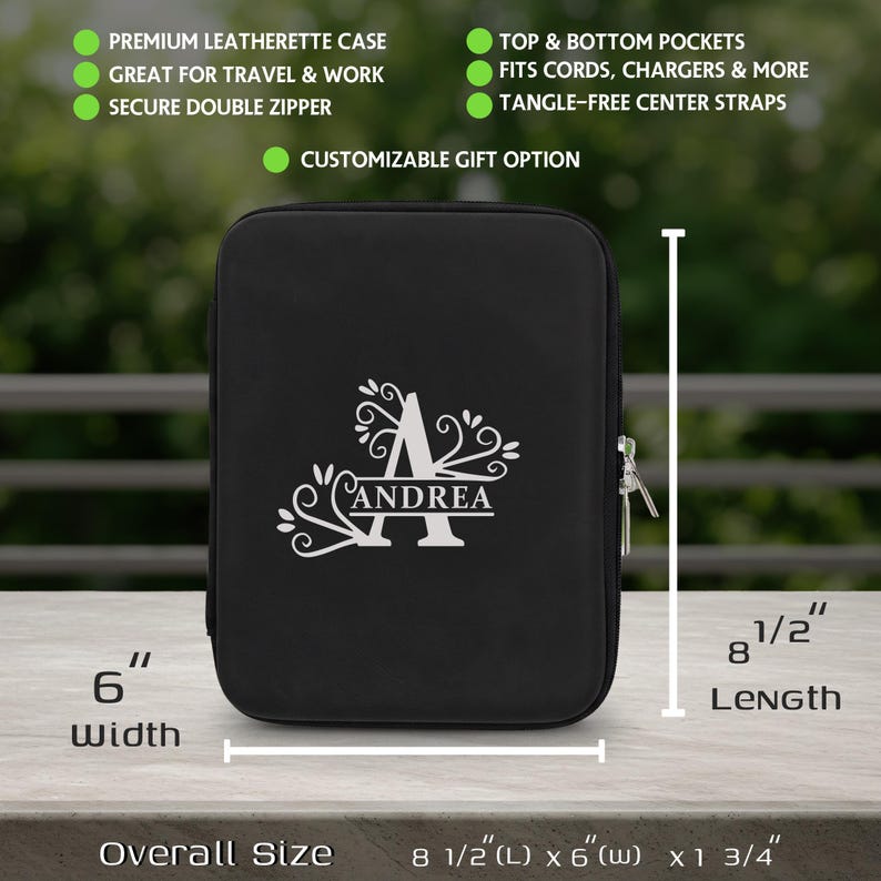 May include: Black leatherette case with a white monogram and the name "Andrea". The case measures 8 1/2" long, 6" wide, and 1 3/4" thick. Features include top and bottom pockets, tangle-free straps, and a secure double zipper. Great for travel and work.