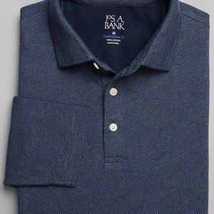 May include: A navy blue long-sleeved polo shirt with a small white pattern. The shirt has a button-down collar and a J.Crew brand label.