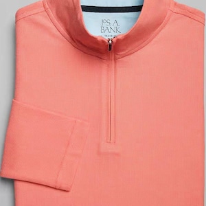 May include: A coral colored long-sleeve shirt with a mock neck and a zipper closure. The shirt has the text "Jos. A. Bank" on the front.