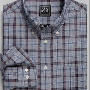 May include: A long-sleeved, button-down shirt with a blue, red, and white plaid pattern. The shirt has a pocket on the left chest and a Jos. A. Bank Traveler label.