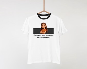 May include: White t-shirt with a black collar and sleeves, featuring a graphic of a cartoon girl with the text "Confidence is the best outfit. Rock it and own it."