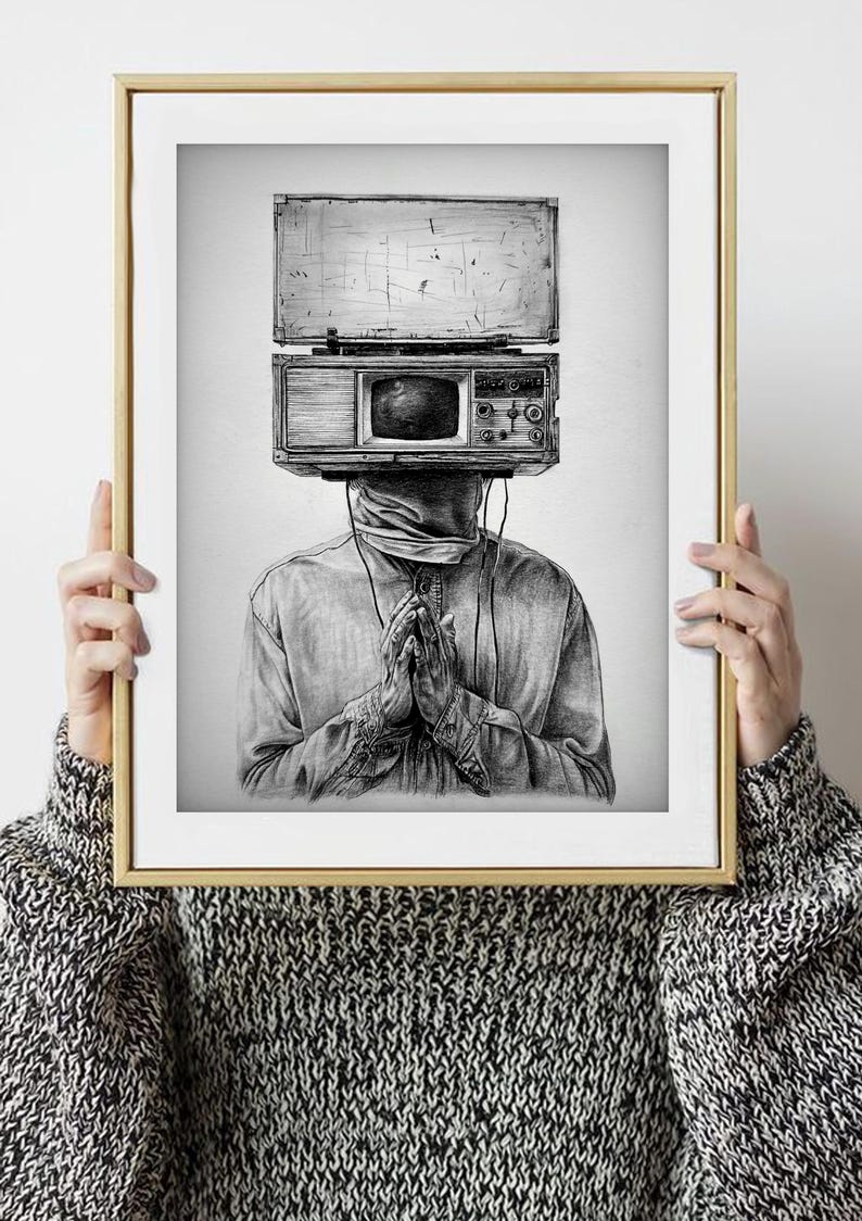May include: Black and white art print of a person with a vintage television and radio in place of a head. The person is wearing a button-down shirt and has their hands clasped in front of them. The artwork is framed in a gold frame.