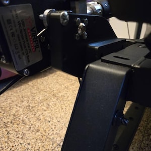 May include: A black metal telescope mount with a silver adjustment knob and a black VIRPIL CONTROLS label. The label reads "USB Joystick for PC, VPC-Rotor Plus, TCS Base, Serial Number: 1234567890".