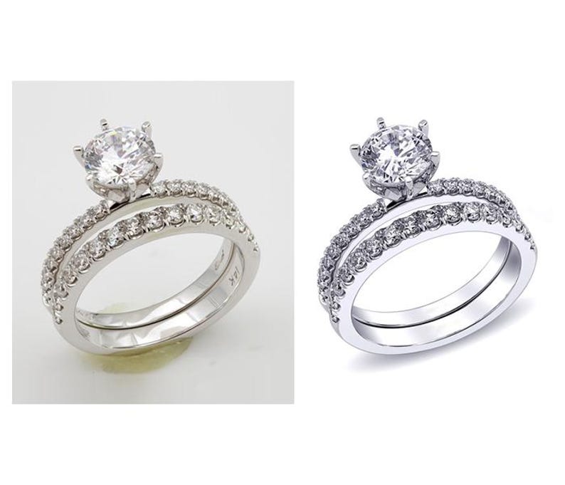 May include: A silver engagement ring set with a large, round, clear gemstone center stone. The band is encrusted with smaller, clear gemstones. The set includes a matching band with similar gemstone detailing.