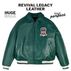 May include: A dark green leather jacket with a zip-up front, a collar, and a patch on the chest. The jacket has white and green striped cuffs and hem. Text on the image reads "REVIVAL LEGACY LEATHER", "HUGE SALE", and "This is perfect".