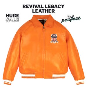 May include: An orange leather jacket with a zipper closure, a collar, and a patch on the chest. The jacket has white and orange striped cuffs and a white stripe at the bottom. Text on the image reads "REVIVAL LEGACY LEATHER" and "HUGE SALE".