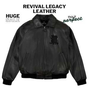 May include: Black leather jacket with a zip-up front, a collar, and a black emblem on the chest. The jacket has a ribbed hem and cuffs. Text on the image reads "REVIVAL LEGACY LEATHER" and "HUGE SALE".