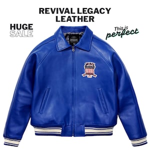 May include: A vibrant blue leather jacket with a zip-up front, a collar, and a patch on the chest. The jacket has white and blue striped cuffs and hem. Text on the image reads "REVIVAL LEGACY LEATHER" and "HUGE SALE".