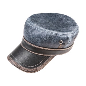 May include: A blue and black leather cap with a stitched brim and a distressed look.