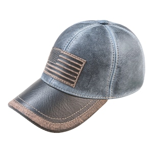 May include: A blue leather baseball cap with a brown leather brim and a brown leather American flag patch on the front.