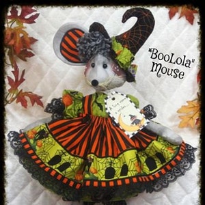 May include: A handmade Halloween mouse doll wearing a black and orange striped dress, a witch hat with a spiderweb, and black shoes with green spiders. The doll is labeled "BooLola Mouse".