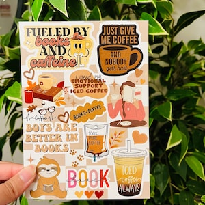 May include: A set of 10 stickers featuring coffee and book-themed illustrations. The stickers include phrases like "Fueled by books and caffeine", "Just give me coffee", "I need my emotional support iced coffee", "Boys are better in books", and "Book lover".