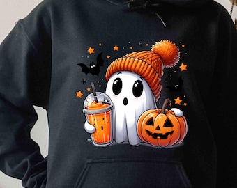 May include: A black hooded sweatshirt featuring a graphic of a white ghost wearing an orange knit beanie with a pom-pom. The ghost holds an orange drink in a clear cup next to a carved orange jack-o'-lantern, surrounded by black bats and orange stars.