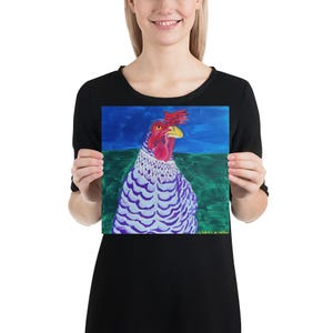 May include: A colorful painting of a chicken with a red comb and wattle, a yellow beak, and a white and purple patterned body. The background features a blue sky and green grass. The artist's signature is visible.