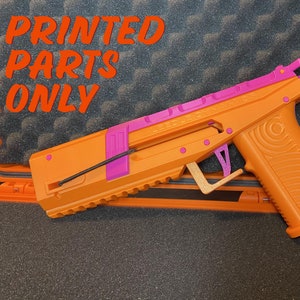 May include: Orange and pink 3D printed gun with the text "SPEED DEMON" on the top. The gun is in a black foam-lined case.