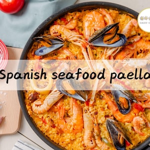 May include: A close-up of a Spanish seafood paella dish in a black pan. The paella is made with rice, seafood, vegetables, and spices. The dish is garnished with fresh herbs.