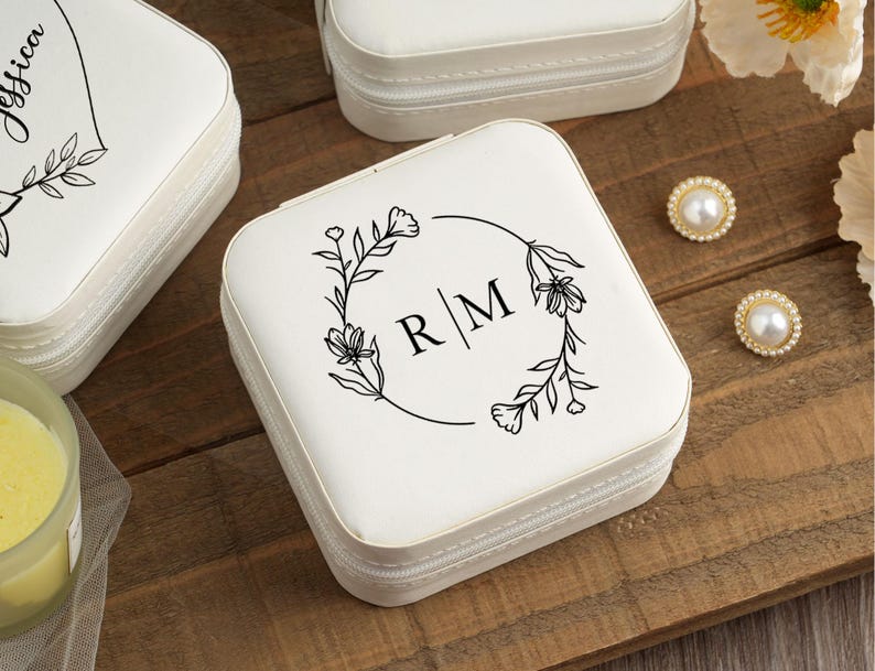 May include: White jewelry box with a floral design and the initials "R/M" on the lid.