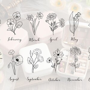May include: A set of 12 black and white line drawings of flowers, each representing a different month of the year. The drawings are arranged in a grid pattern on a white background. The months are labeled below each drawing.