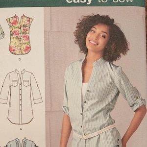 May include: A sewing pattern for a shirt with different variations. The pattern includes a striped shirt, a floral shirt, a plaid shirt, a solid shirt, and a shirt with ruffles. The pattern is for sizes 6, 9, 10, and 12. The pattern is from Simplicity and is easy to sew.