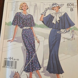 May include: Vintage sewing pattern for two dresses. The pattern is for sizes 6-12 and is from Simplicity's 60th anniversary collection. The pattern shows two women wearing the dresses, one with a floral print and the other with a solid blue dress. The pattern is labeled 9360.