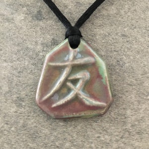 May include: A set of three ceramic mugs with a speckled, cream-colored glaze. Each mug features a different hand-painted design: a sun, a moon, and a star. The mugs have a minimalist, modern aesthetic.