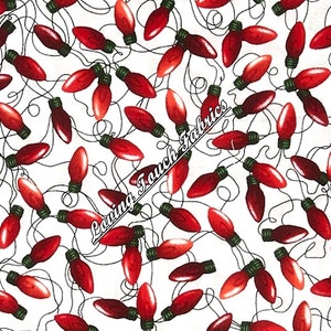 May include: White fabric with a repeating pattern of red Christmas lights. The lights are connected by black wires and have green tips. The fabric has a ruler at the bottom with inches marked.