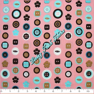 May include: Pink fabric with a repeating pattern of various sized buttons in brown, black, white, and blue. The buttons are in different shapes, including circles, squares, and flowers. The fabric has a subtle texture and a soft, smooth feel.