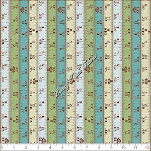 May include: Fabric with a ruler design in shades of green, blue, and tan. The fabric features vertical stripes with inch and centimeter measurements, and the text "Loving Touch Fabrics".
