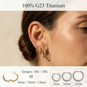 May include: Three gold-colored hoop earrings in varying sizes worn in an earlobe. The text 100% G23 Titanium, Gauges: 16G / 18G, and 8mm / 10mm / 12mm is visible. The image displays three silver-toned hoop earrings in 8mm, 10mm, and 12mm sizes.