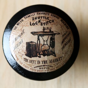 May include: A black and white vintage sewing machine advertisement with the text "The Weed Family Favorite Shuttle Lock Stitch Sewing Machine" and "The Best in the Market".