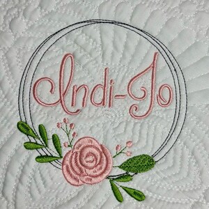 Embroidered personalized heirloom baby quilt with Flower wreath