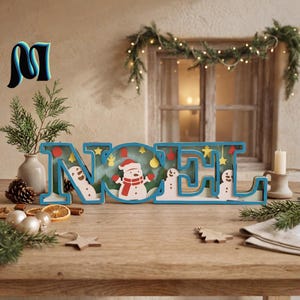 May include: A blue wooden decorative sign spelling the word NOEL with layered cutouts of snowmen, stars, and holiday ornaments inside the letters. The design features a central snowman wearing a red scarf and mittens against a light background.