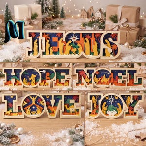 May include: A collection of layered wooden signs featuring cutout letters that spell JESUS, HOPE, NOEL, LOVE, and JOY. Each sign displays a multi-colored nativity scene silhouette with palm trees, figures, and stars against a deep blue background.