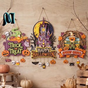 May include: Three layered wooden wall signs for Halloween. The left sign features a purple cauldron with the text Trick or Treat. The center sign shows a haunted house and moon with the text Happy Halloween. The right sign depicts a scarecrow with the text Spooky Season.