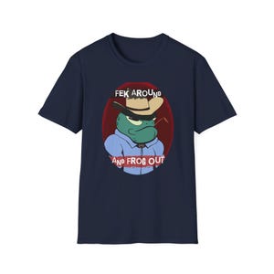 May include: A navy blue t-shirt with a cartoon frog wearing a cowboy hat and the text "FEK AROUND AND FROG OUT".