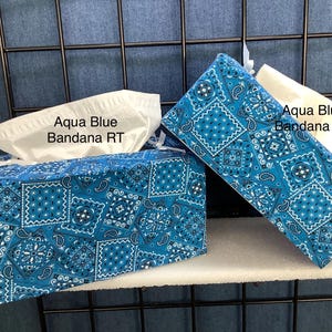 May include: Two tissue box covers in aqua blue bandana print fabric. One is rectangular, the other is a long, narrow shape. Both have white tissue peeking out. The text "Aqua Blue Bandana RT" and "Aqua Blue Bandana RS" are visible.