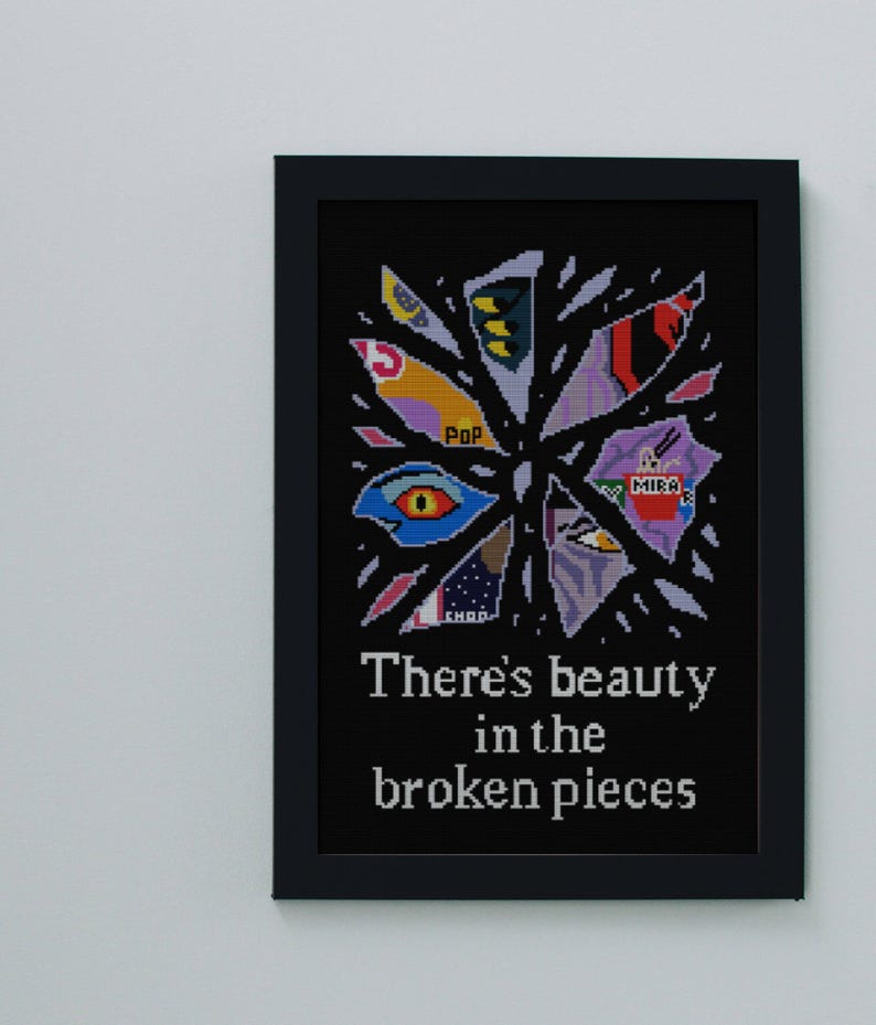 May include: Framed artwork with a black background featuring a colorful, abstract design of fragmented shapes. The artwork includes the text "There's beauty in the broken pieces" in white, with a black frame.
