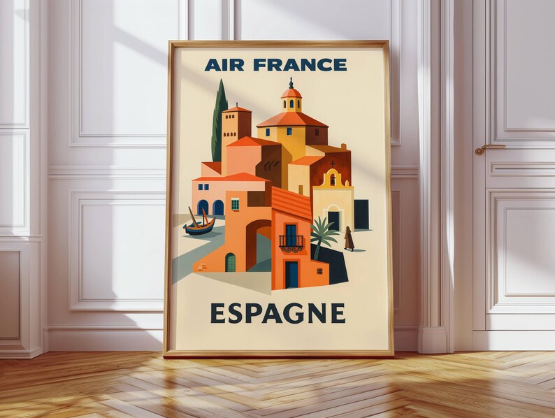 May include: A framed vintage travel poster for Air France, featuring a stylized illustration of a Spanish coastal town. The artwork showcases buildings in shades of orange, yellow, and brown, with the word "ESPAGNE" at the bottom.
