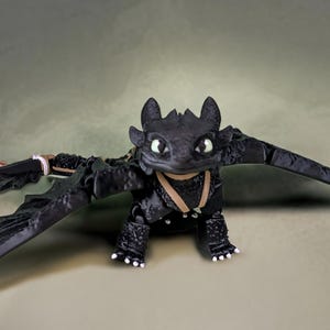 Toothless How to train your dragon with multiple expressions! Glow in the dark eyes! Articulated Figure stands or sits! Great Gift!