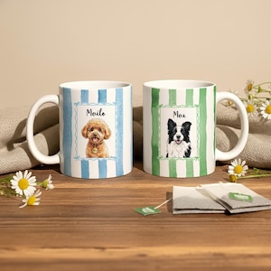 May include: Two white ceramic mugs featuring dog portraits. One mug has blue and white stripes and a poodle named "Mailo." The other mug has green and white stripes and a border collie named "Max."