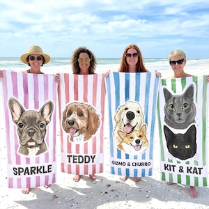 May include: Four rectangular beach towels featuring vertical stripes and custom pet portraits. The first towel has a pink stripe pattern with a French Bulldog labelled SPARKLE. The second has red stripes with a dog labelled TEDDY. The third has blue stripes with two dogs labelled GIZMO & CHURRO. The fourth has green stripes with two cats labelled KIT & KAT.