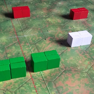 May include: A game board with black, white, red and green game pieces. The pieces are arranged in rows on the board.