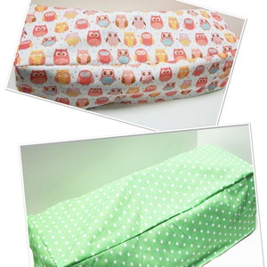 May include: Two rectangular fabric containers. The top one features a white background with colorful owl illustrations. The bottom container is light green with white polka dots. Both containers appear to be handmade.