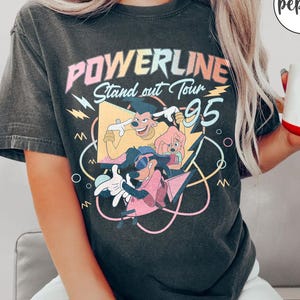May include: A black t-shirt with a vintage-style graphic featuring the text "Powerline Stand out Tour '95" and cartoon characters.