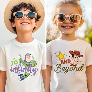 May include: Two children wearing white t-shirts with cartoon graphics. One shirt features Buzz Lightyear with the text "To Infinity" and a rocket. The other shirt has a sheriff's badge, Woody, and the words "And Beyond".