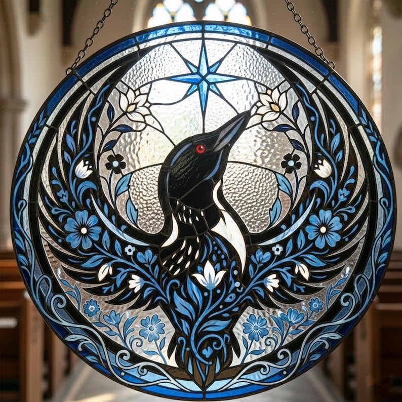 May include: Circular stained glass window featuring a black and white bird with a red eye, surrounded by blue floral patterns and a blue star. The window is framed with a dark blue border and hangs from a chain.