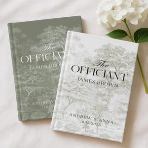 May include: Two hardcover books with the text "The Officiant" and "James Brown" printed on the cover. The books have a tree design and the names "Andrew & Anna" and the date "10.15.2025" printed on the bottom. One book is sage green, the other is white.
