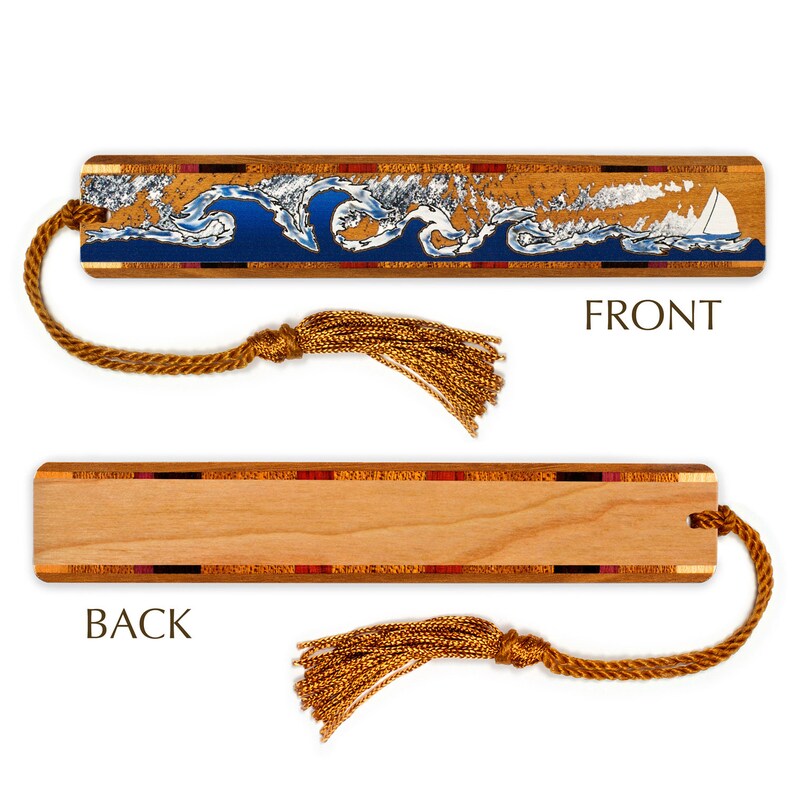May include: A wooden bookmark with a blue and white wave design and a sailboat on the front. The back of the bookmark is plain wood with a decorative border. The bookmark has a gold tassel.